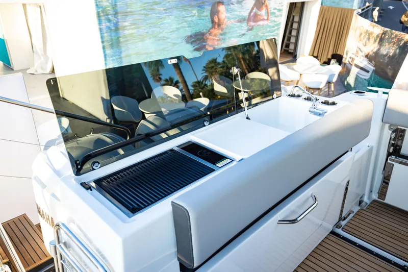 Slide: The Image of 2026 Jeanneau NC 895 Sport Series 2 boat deck with grill and seating area. - 17