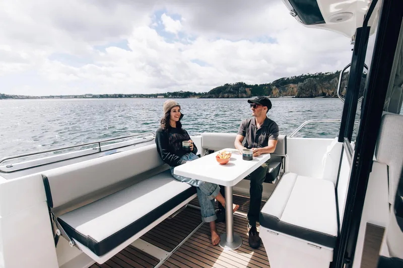 Slide: The Image of Couple enjoying a relaxing moment on a 2026 Jeanneau NC 895 Sport Series 2 boat. - 18