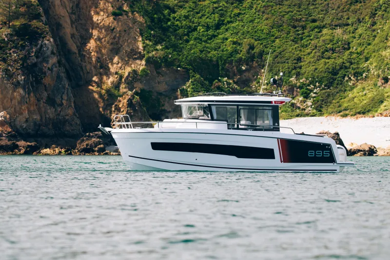 Slide: The Image of 2026 Jeanneau NC 895 Sport Series 2 boat cruising near rocky coastline. - 3