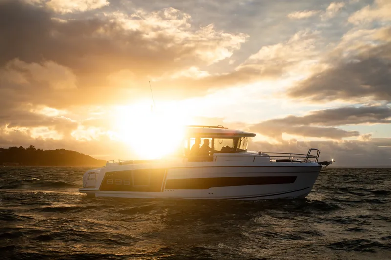 Slide: The Image of 2026 Jeanneau NC 895 Sport Series 2 boat at sunset on the water. - 8