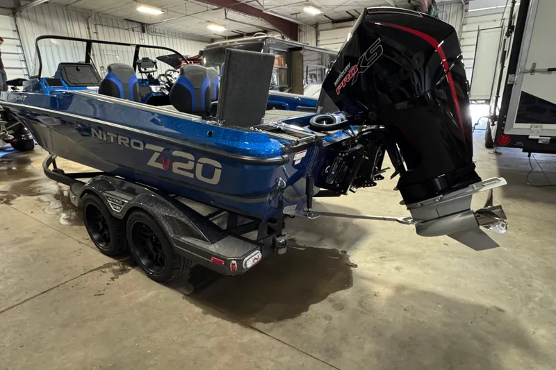 Slide: The Image of 2026 Nitro ZV20 Sport Pro boat with powerful outboard motor in a garage setting. - 5