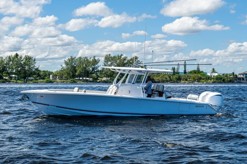 Slide: The Image of 2022 Jupiter 32 boat cruising on a sunny day with clear skies and calm waters. - 1