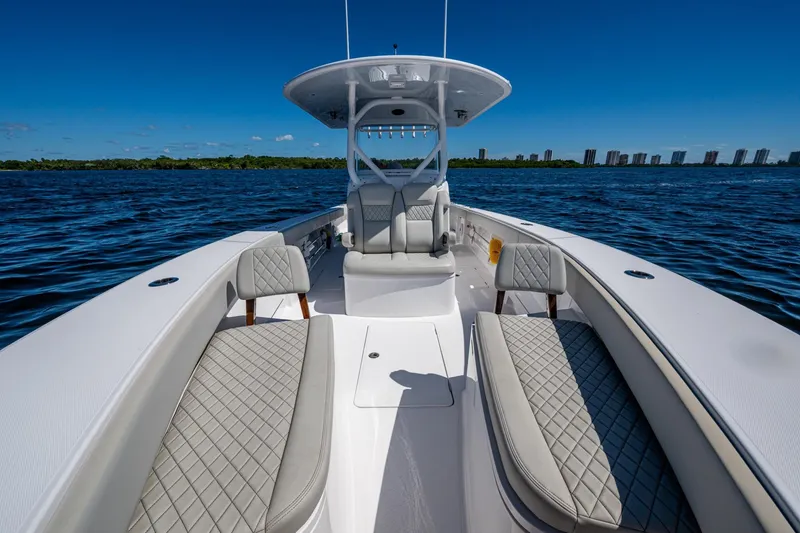 Slide: The Image of 2022 Jupiter 32 boat on water, featuring luxurious seating and clear blue skies. - 10