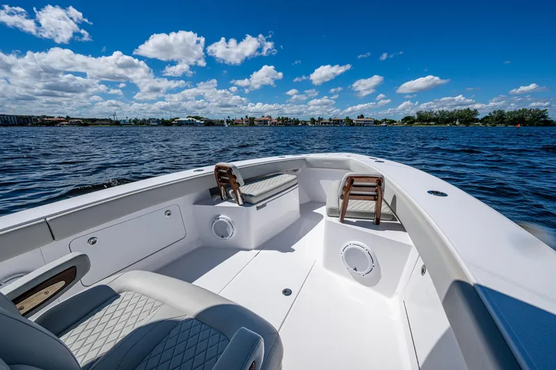 Slide: The Image of 2022 Jupiter 32 boat interior with seating, on a sunny day, overlooking calm waters. - 11