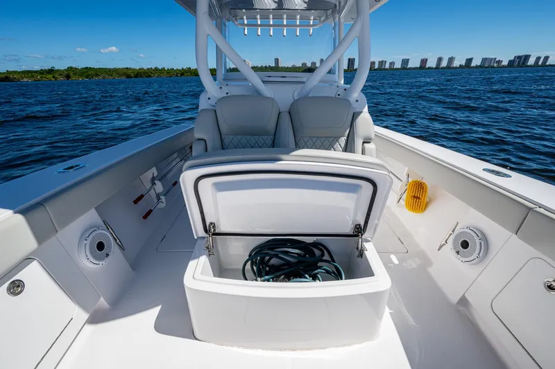 Slide: The Image of 2022 Jupiter 32 boat interior with open storage compartment on a sunny day. - 14