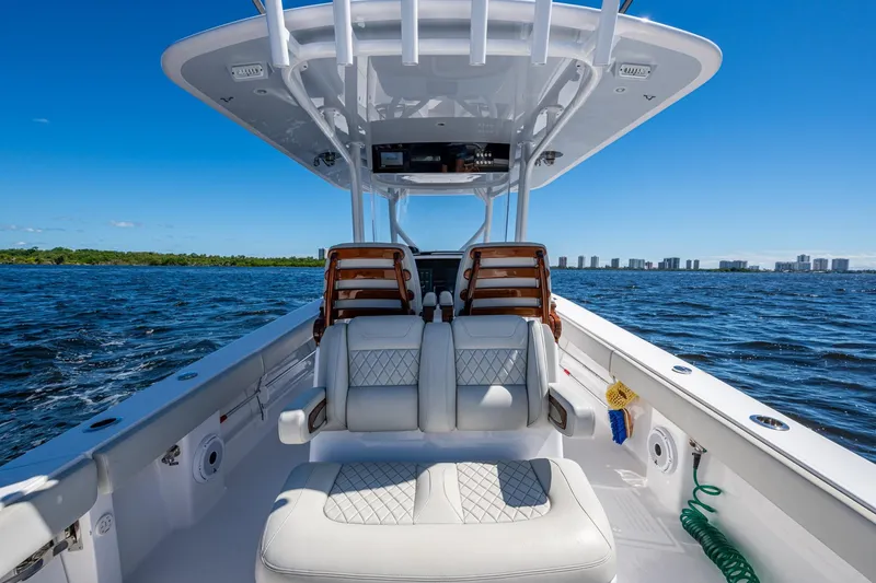Slide: The Image of 2022 Jupiter 32 boat interior on open water, featuring luxurious seating and clear blue skies. - 15