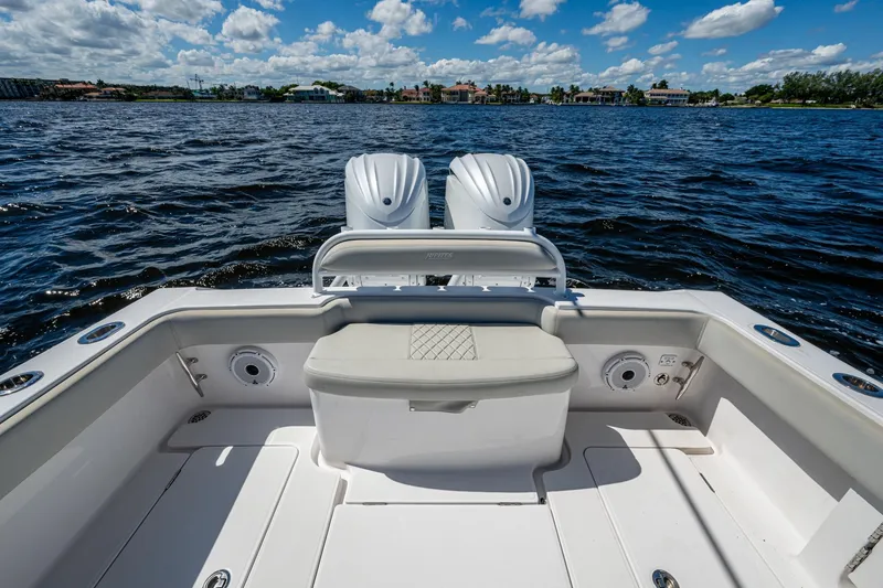 Slide: The Image of 2022 Jupiter 32 boat with dual engines on a sunny day, open water view. - 16