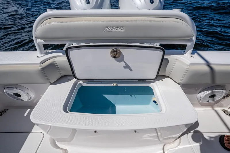 Slide: The Image of 2022 Jupiter 32 boat with open storage compartment on deck, near water. - 18