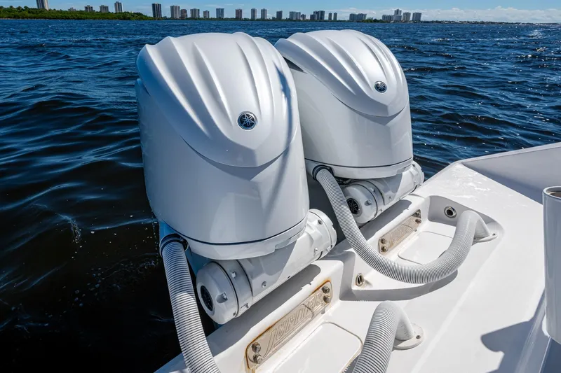 Slide: The Image of Twin outboard engines on a 2022 Jupiter 32 boat, cruising on open water. - 24
