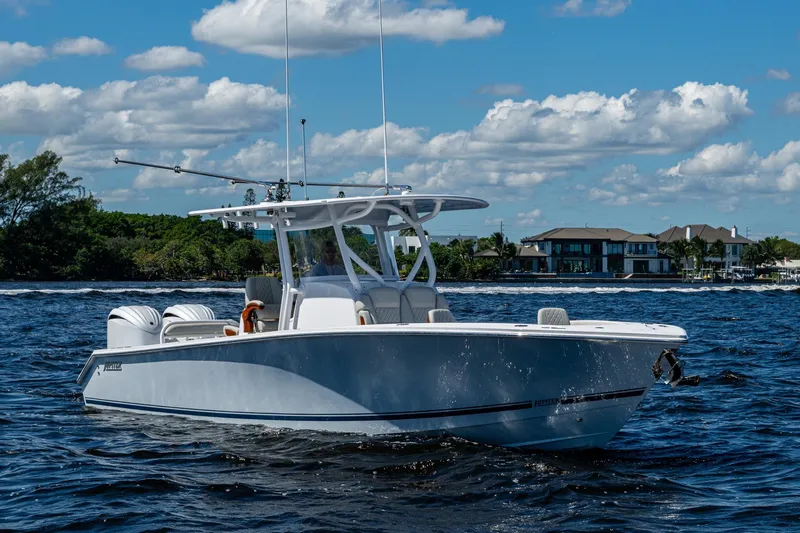 Slide: The Image of 2022 Jupiter 32 boat cruising on a sunny day with coastal homes in the background. - 27