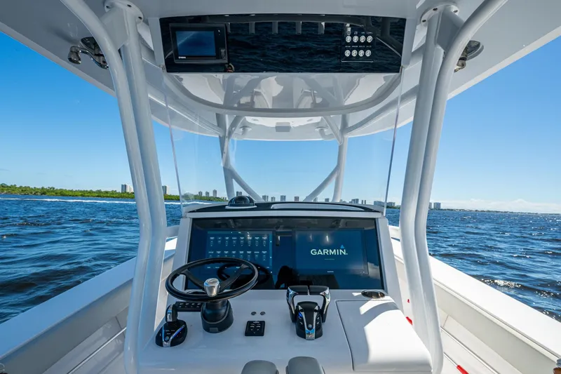 Slide: The Image of Cockpit view of 2022 Jupiter 32 boat with Garmin navigation system on open water. - 5