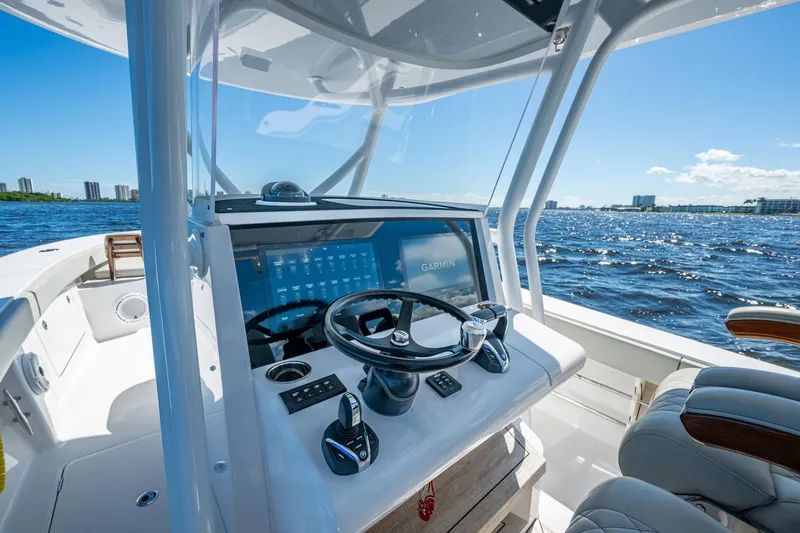 Slide: The Image of 2022 Jupiter 32 boat helm with Garmin display on open water. - 6