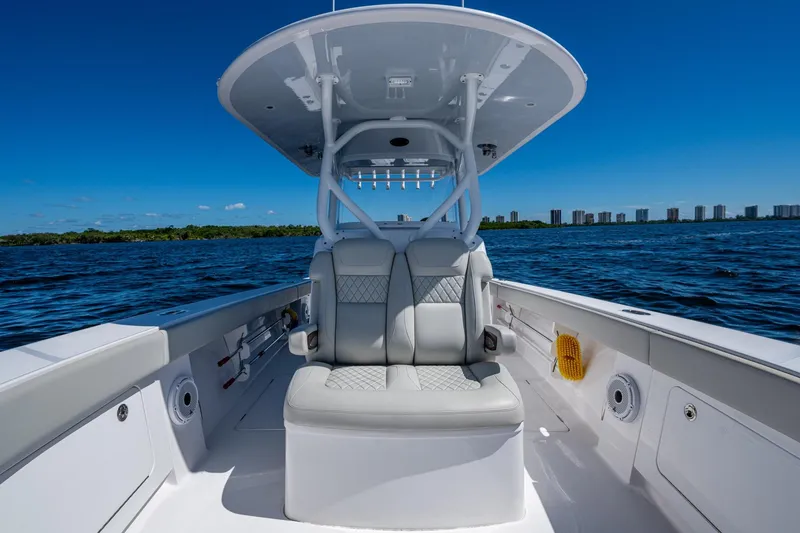 Slide: The Image of 2022 Jupiter 32 boat interior with cushioned seating on open water. - 9