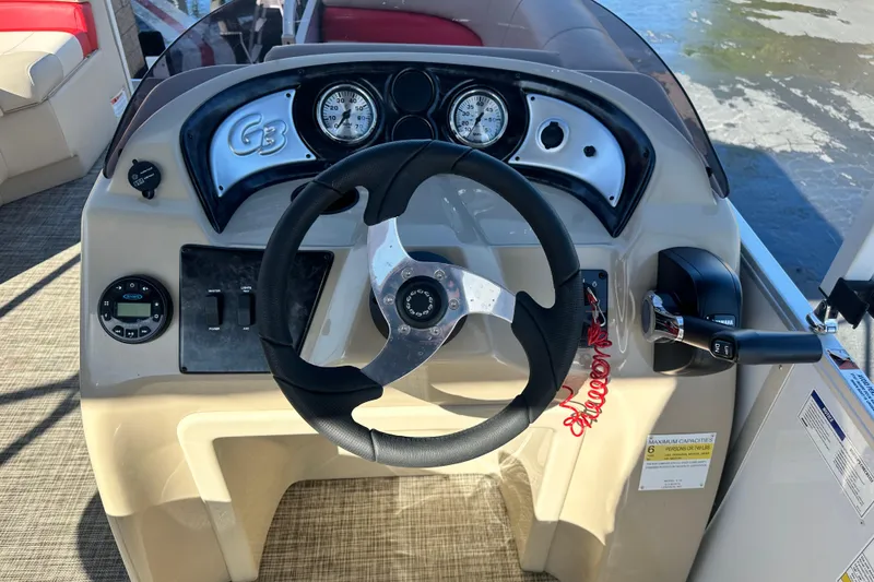 Slide: The Image of 2020 G3 SunCatcher V16 Cruise boat dashboard with steering wheel and controls. - 11