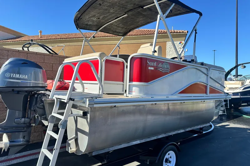 Slide: The Image of 2020 G3 SunCatcher V16 Cruise pontoon boat with Yamaha motor, parked outdoors. - 4