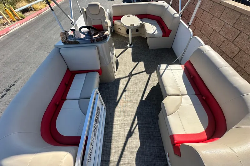 Slide: The Image of 2020 G3 SunCatcher V16 Cruise pontoon boat with beige and red seating, docked on pavement. - 6