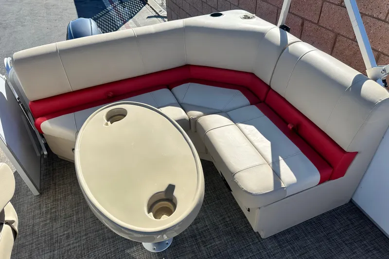 Slide: The Image of 2020 G3 SunCatcher V16 Cruise pontoon boat interior with beige and red seating, oval table. - 9