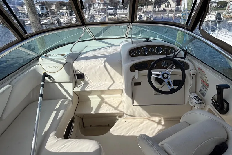 Slide: The Image of Interior view of 2000 Sea Ray 240 Sundancer boat cockpit with steering wheel and controls. - 4