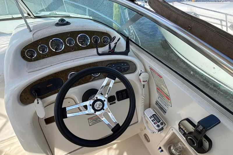 Slide: The Image of Cockpit of 2000 Sea Ray 240 Sundancer with steering wheel and control panel. - 6
