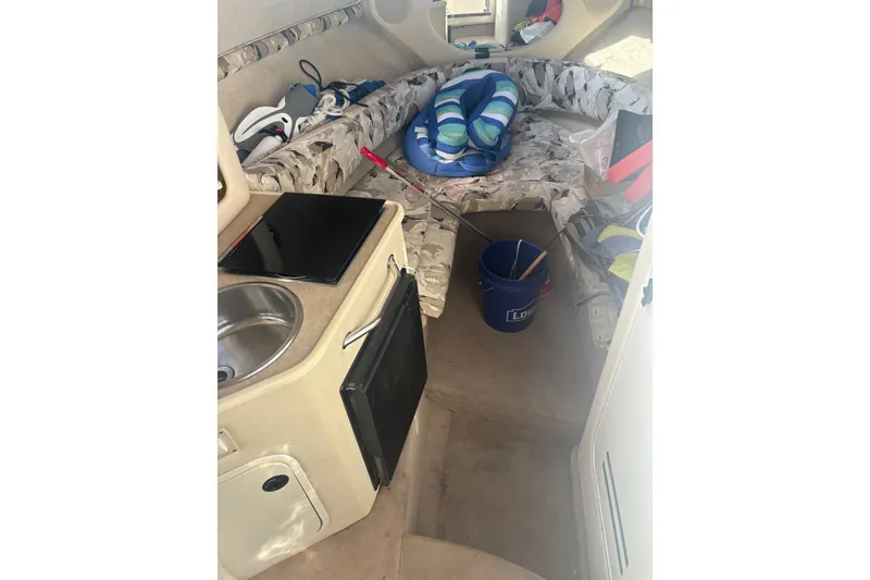 Slide: The Image of Interior of a 2000 Sea Ray 240 Sundancer boat with seating, sink, and storage. - 7