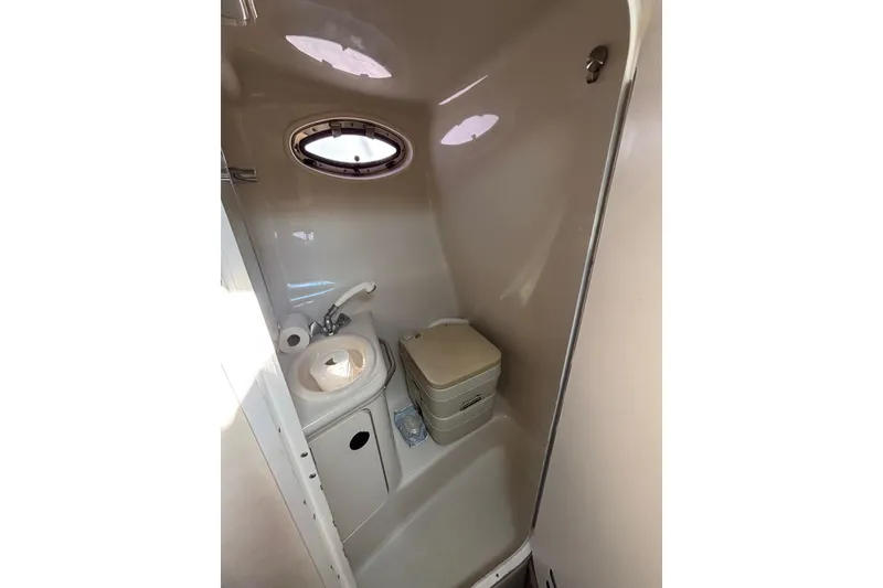 Slide: The Image of Compact bathroom in 2000 Sea Ray 240 Sundancer boat with sink and toilet. - 9