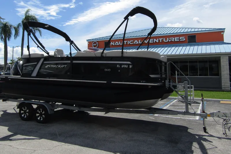 The Image of 2021 Starcraft SLS 1 pontoon boat on trailer at Nautical Ventures dealership. - 0