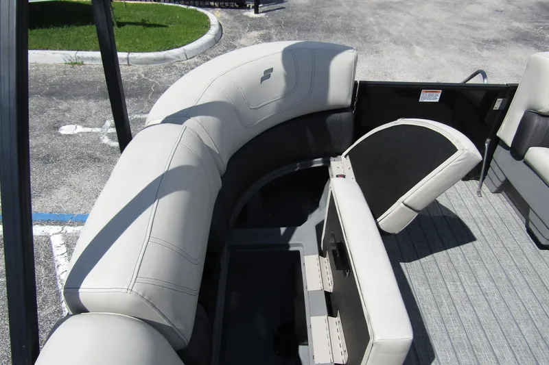 Slide: The Image of 2021 Starcraft SLS 1 boat interior with gray cushioned seating and storage compartment. - 10