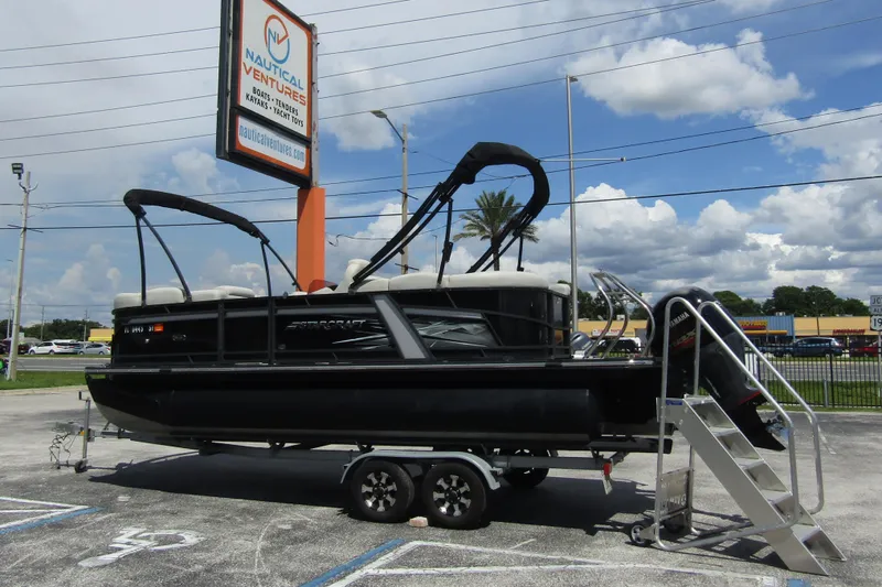 Slide: The Image of 2021 Starcraft SLS 1 pontoon boat on trailer at Nautical Ventures dealership. - 3
