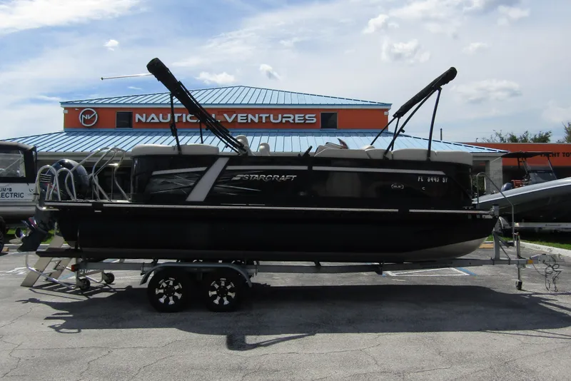 Slide: The Image of 2021 Starcraft SLS 1 pontoon boat on trailer at Nautical Ventures dealership. - 6