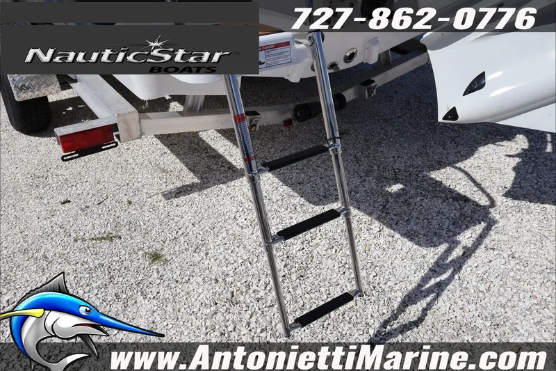 Slide: The Image of 2025 NauticStar 231 Hybrid boat ladder and trailer, Antonietti Marine branding. - 10