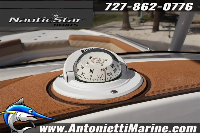 Slide: The Image of 2025 NauticStar 231 Hybrid boat compass with contact details and logo. - 14