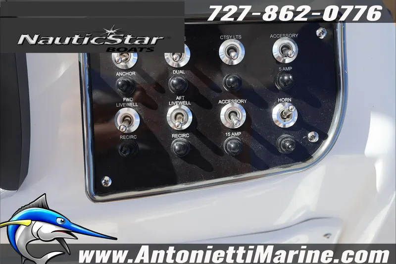 Slide: The Image of Control panel of 2025 NauticStar 231 Hybrid boat with switches and branding. - 16