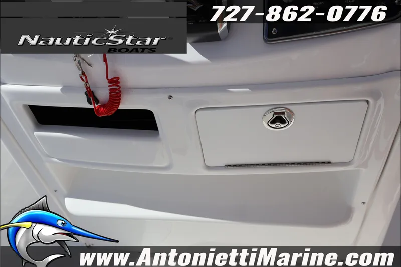 Slide: The Image of 2025 NauticStar 231 Hybrid boat dashboard with storage and safety features. - 17