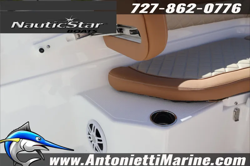 Slide: The Image of 2025 NauticStar 231 Hybrid boat interior with tan seating and cup holder. - 26