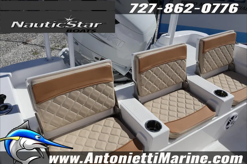 Slide: The Image of 2025 NauticStar 231 Hybrid boat seats with tan upholstery and cup holders. - 38