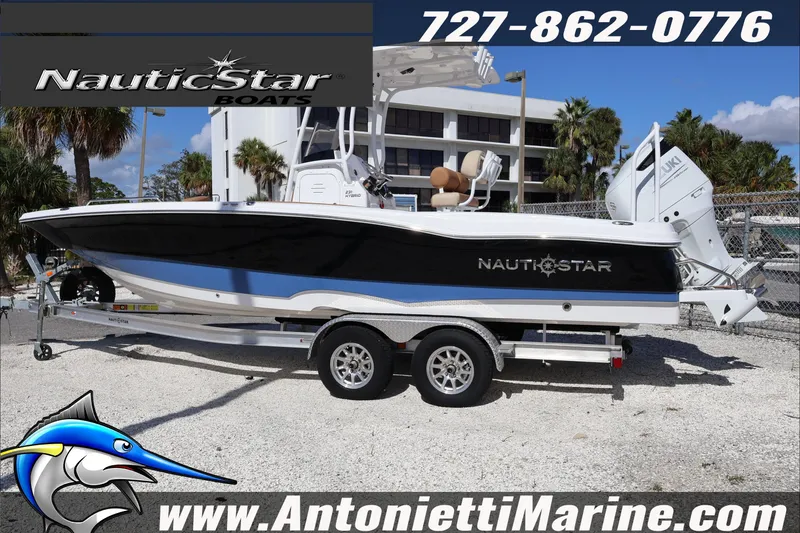 Slide: The Image of 2025 NauticStar 231 Hybrid boat on trailer at Antonietti Marine dealership. - 7