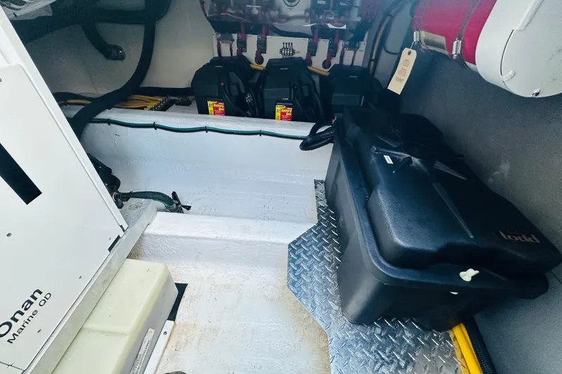 Slide: The Image of 2024 Back Cove 34O boat with striped seating and triangular table on deck. - 18