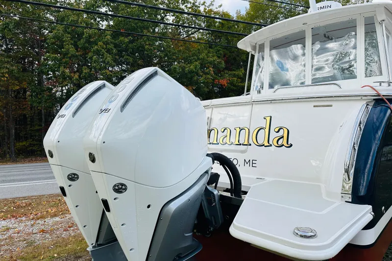 Slide: The Image of 2024 Back Cove 34O engine compartment with organized storage and sleek design. - 27