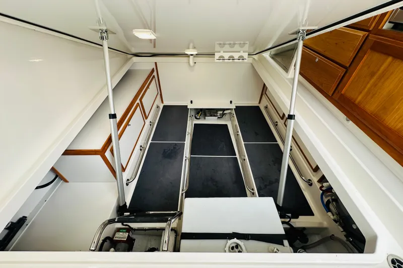 Slide: The Image of Engine compartment of 2024 Back Cove 34O boat, showcasing mechanical components and wiring. - 30