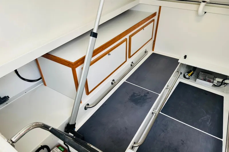 Slide: The Image of 2024 Back Cove 34O engine compartment with water heater and filtration system. - 31