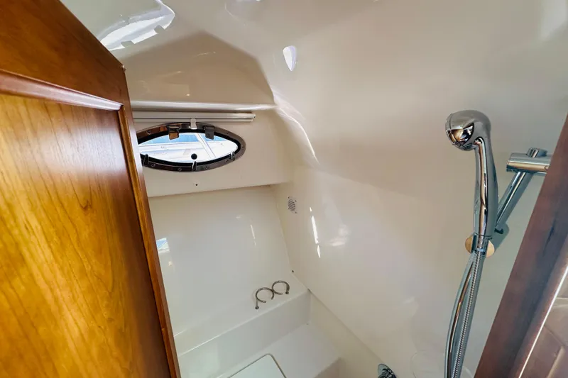 Slide: The Image of 2024 Back Cove 34O interior with modern kitchen, seating, and helm station. - 9