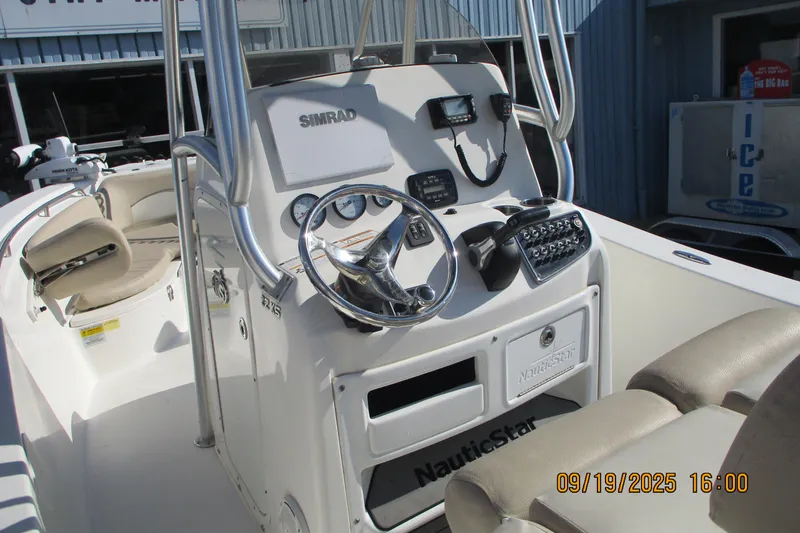 Slide: The Image of 2018 NauticStar 22 XS Offshore boat console with steering wheel and navigation equipment. - 10