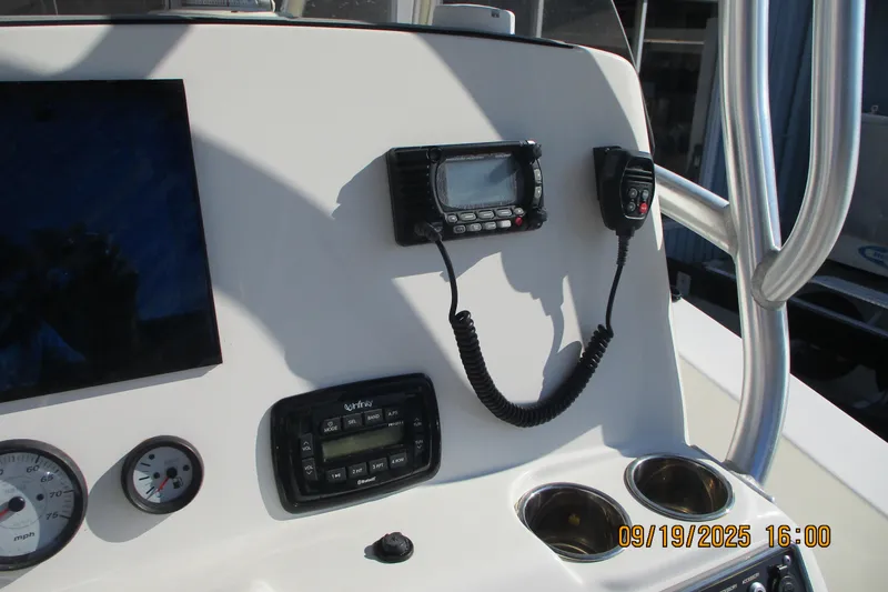 Slide: The Image of 2018 NauticStar 22 XS Offshore boat dashboard with radio and gauges. - 12
