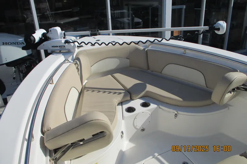 Slide: The Image of 2018 NauticStar 22 XS Offshore boat with beige seating and Minn Kota trolling motor. - 14