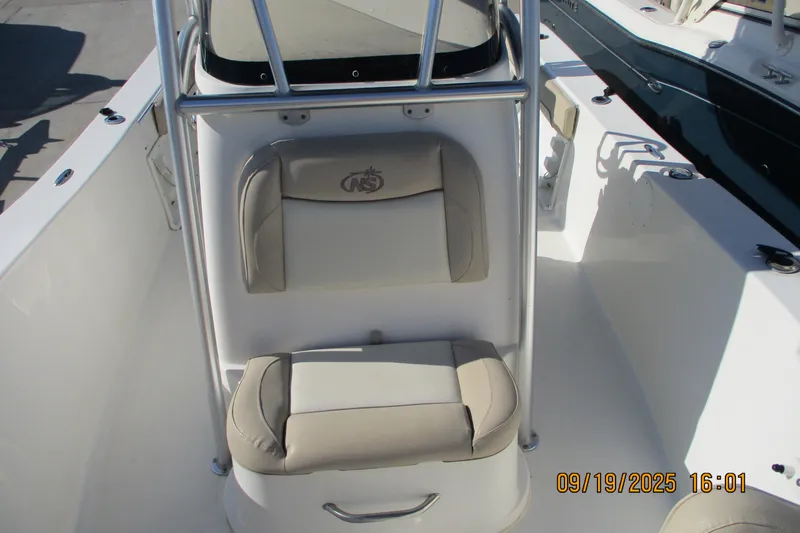 Slide: The Image of 2018 NauticStar 22 XS Offshore boat interior with cushioned seating and console. - 15