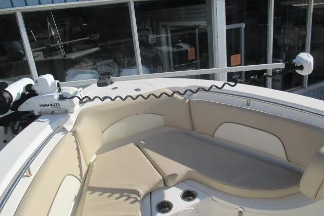 Slide: The Image of 2018 NauticStar 22 XS Offshore boat with cushioned seating and Minn Kota trolling motor. - 18