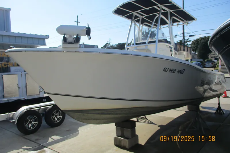 Slide: The Image of 2018 NauticStar 22 XS Offshore boat on display, elevated on blocks. - 5