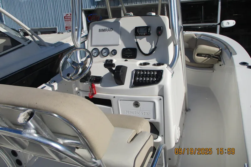 Slide: The Image of 2018 NauticStar 22 XS Offshore boat console with steering wheel and controls. - 7