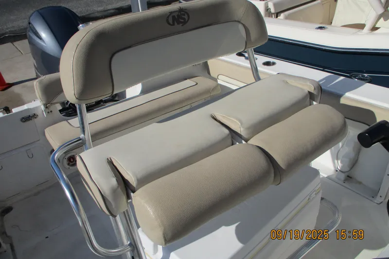 Slide: The Image of 2018 NauticStar 22 XS Offshore boat seating with beige upholstery and stainless steel frame. - 9
