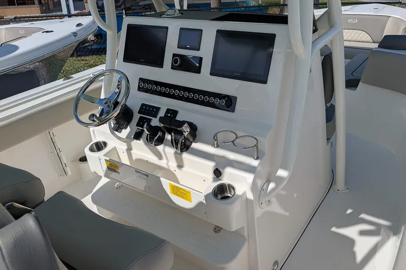 Slide: The Image of 2025 Key West 263 FS boat console with steering wheel and electronic displays. - 12